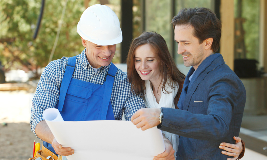construction loans: couple reviewing plans with builder.
