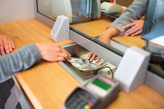 person receiving money from bank.