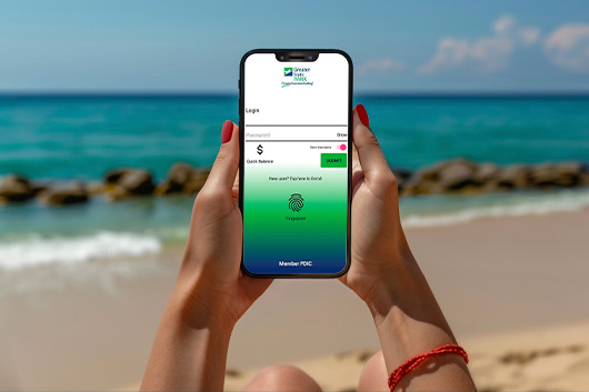 Greater State Bank online mobile app. Person using it at the beach